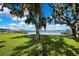Scenic water view with a swing under mature trees, creating a peaceful outdoor space at 550 George S St, Tarpon Springs, FL 34688