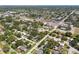 This aerial view displays the community neighborhood near a pond and commercial areas at 5624 62Nd N St, St Petersburg, FL 33709