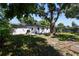 Lush backyard with mature trees, a quaint patio area, and ample green space for relaxation at 5624 62Nd N St, St Petersburg, FL 33709