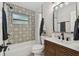 Updated bathroom featuring a modern vanity, patterned tile, shower and well-placed fixtures at 5624 62Nd N St, St Petersburg, FL 33709
