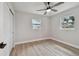Bright and airy bedroom with windows, laminate flooring, neutral paint, and closet at 5624 62Nd N St, St Petersburg, FL 33709