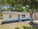Inviting single-story home with a charming exterior and well-maintained landscaping at 5624 62Nd N St, St Petersburg, FL 33709