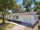 Charming single-story home featuring an attached garage and manicured landscaping at 5624 62Nd N St, St Petersburg, FL 33709