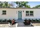 A close-up reveals the charming exterior with an attractive front door and stylish landscaping at 5624 62Nd N St, St Petersburg, FL 33709