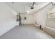 Spacious garage featuring concrete block walls, painted floor, overhead lighting, and garage door opener at 5624 62Nd N St, St Petersburg, FL 33709