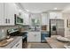 Modern kitchen featuring white cabinets, stainless steel appliances, granite countertops and patterned backsplash at 5624 62Nd N St, St Petersburg, FL 33709