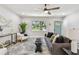 Bright living room with a comfortable gray sofa, hardwood floors, and stylish decor at 5624 62Nd N St, St Petersburg, FL 33709