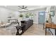 Comfortable living room with hardwood floors, a gray sofa, and natural lighting at 5624 62Nd N St, St Petersburg, FL 33709