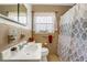 Cozy bathroom with patterned shower curtain, neutral tile, and a built-in soap dish at 5711 9Th N Ave, St Petersburg, FL 33710