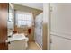 Functional bathroom with neutral tile, a shower curtain, and built-in storage cabinet at 5711 9Th N Ave, St Petersburg, FL 33710