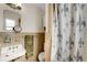Modest bathroom featuring neutral tile, a pedestal sink, and a classic shower curtain at 5711 9Th N Ave, St Petersburg, FL 33710