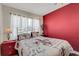 Cozy bedroom with a ceiling fan, natural light, and red accent wall at 5711 9Th N Ave, St Petersburg, FL 33710
