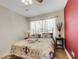 Cozy bedroom with a ceiling fan, natural light, and red accent wall at 5711 9Th N Ave, St Petersburg, FL 33710