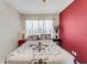 Cozy bedroom with a ceiling fan, natural light, and red accent wall at 5711 9Th N Ave, St Petersburg, FL 33710