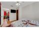 Cozy bedroom with a ceiling fan, natural light, and red accent wall at 5711 9Th N Ave, St Petersburg, FL 33710