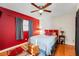 Bright bedroom with hardwood floors, a large bed, and a window providing natural light at 5711 9Th N Ave, St Petersburg, FL 33710