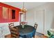 Bright dining room with red accent wall and seating for four at 5711 9Th N Ave, St Petersburg, FL 33710