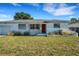 Charming single-story home with a well-maintained lawn, bright red door, and inviting curb appeal at 5711 9Th N Ave, St Petersburg, FL 33710