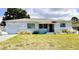 Charming single-story home with light blue paint, attached garage, and decorative flower trim at 5711 9Th N Ave, St Petersburg, FL 33710
