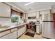 Functional kitchen with white cabinets and a stainless-steel refrigerator at 5711 9Th N Ave, St Petersburg, FL 33710