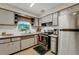 Bright kitchen featuring white cabinets, stainless steel appliances, and lots of storage at 5711 9Th N Ave, St Petersburg, FL 33710