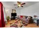Cozy living room with hardwood floors, ceiling fan, and comfortable seating with a flat screen television at 5711 9Th N Ave, St Petersburg, FL 33710
