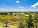 Picturesque aerial shot showcasing the vast natural landscape and a pond nearby, enhancing the property's appeal at 577 Waterfall Dr, Spring Hill, FL 34608