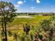Aerial view showing serene landscape, a pond, and abundant trees, highlighting the property's peaceful environment at 577 Waterfall Dr, Spring Hill, FL 34608