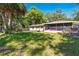 Backyard featuring a well-maintained lawn, a chain-link fence, and partial views of the home's exterior at 577 Waterfall Dr, Spring Hill, FL 34608
