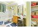Full bathroom with yellow walls and tile floors at 577 Waterfall Dr, Spring Hill, FL 34608
