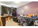 This bedroom features a desk, TV, and a twin-sized bed covered with a blue-and-white patterned blanket at 577 Waterfall Dr, Spring Hill, FL 34608