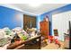 Bedroom with blue walls, furniture, and a bed at 577 Waterfall Dr, Spring Hill, FL 34608