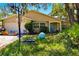 Charming home with a basketball hoop, turquoise door, and lush green lawn at 577 Waterfall Dr, Spring Hill, FL 34608