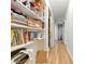 The hallway has hardwood floors and built-in bookshelves along one wall, ready for organization at 577 Waterfall Dr, Spring Hill, FL 34608