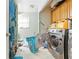 Laundry room with a washing machine and dryer and storage cabinets at 577 Waterfall Dr, Spring Hill, FL 34608