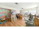 Open-concept living room with unique wall art and hardwood floors, offers a canvas for personalization at 577 Waterfall Dr, Spring Hill, FL 34608