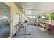 Covered patio with chairs, tables and view to the backyard at 577 Waterfall Dr, Spring Hill, FL 34608