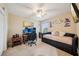 Cozy bedroom with a ceiling fan, art, a day bed and a desk with monitors in a pleasing arrangement at 601 52Nd Ter N, St Petersburg, FL 33703