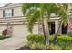 Beautiful townhome showcasing stone accents, palm trees, and inviting front entrance at 601 52Nd Ter N, St Petersburg, FL 33703