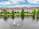 Back view of townhomes with a lake view, fountain, green grass and landscaping at 601 52Nd Ter N, St Petersburg, FL 33703