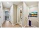Bright hallway featuring light-wood floors and access to a bedroom and bathroom at 601 52Nd Ter N, St Petersburg, FL 33703