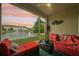 Relaxing screened patio with comfortable seating and tranquil water view at sunset at 601 52Nd Ter N, St Petersburg, FL 33703