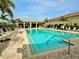 Community pool featuring lounge chairs and a shaded lounge area at 601 52Nd Ter N, St Petersburg, FL 33703