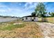 View of the backyard, featuring a shed, privacy fence, and ample lawn space at 6403 N Lois Ave, Tampa, FL 33614