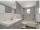 Renovated bathroom featuring marble tile, modern vanity, and updated fixtures at 6403 N Lois Ave, Tampa, FL 33614