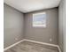 This is a simple bedroom with gray walls and light wood-look flooring at 6403 N Lois Ave, Tampa, FL 33614