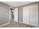 Bedroom features wood-look floors, closet, and multiple doorways at 6403 N Lois Ave, Tampa, FL 33614