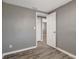 Bedroom features a gray wall and light trim and wood-look floors at 6403 N Lois Ave, Tampa, FL 33614