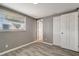 Bedroom features a window and a closet with gray walls and light trim and wood-look floors at 6403 N Lois Ave, Tampa, FL 33614