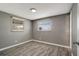 Bedroom features two windows and gray walls with light trim and wood-look floors at 6403 N Lois Ave, Tampa, FL 33614